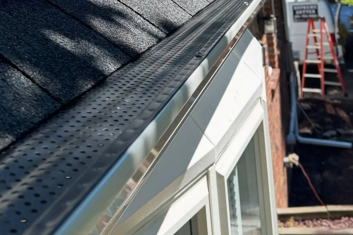 Gutter guard fitted along a shingle roof edge in Salem, Oregon